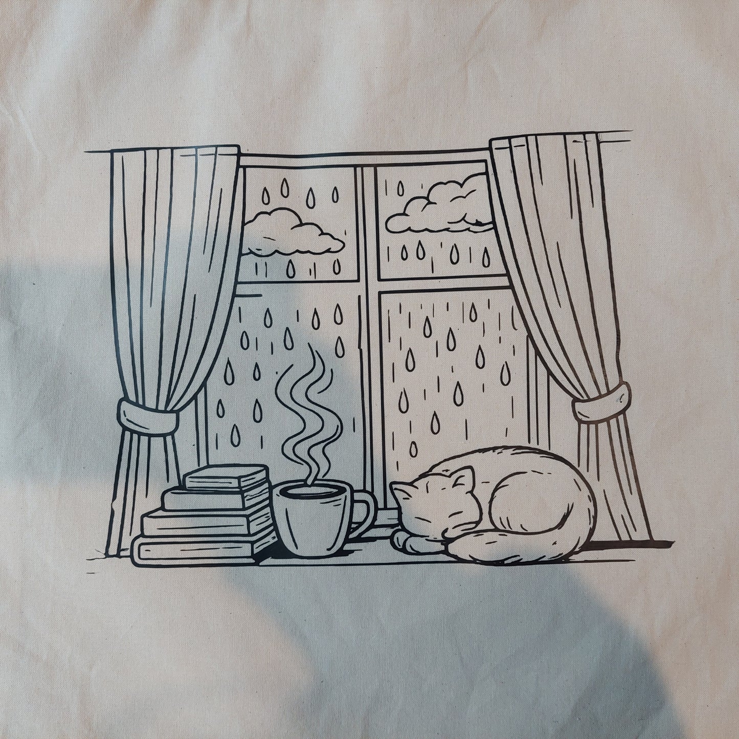 Tote gatito y lluvia